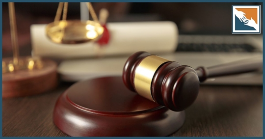 Gavel on block near a probate document and scales of justice